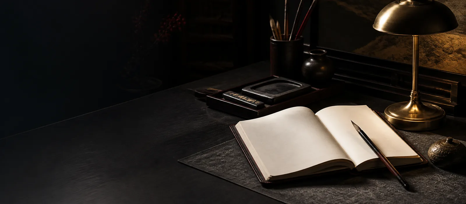 An open blank journal, brush and inkstone under warm light